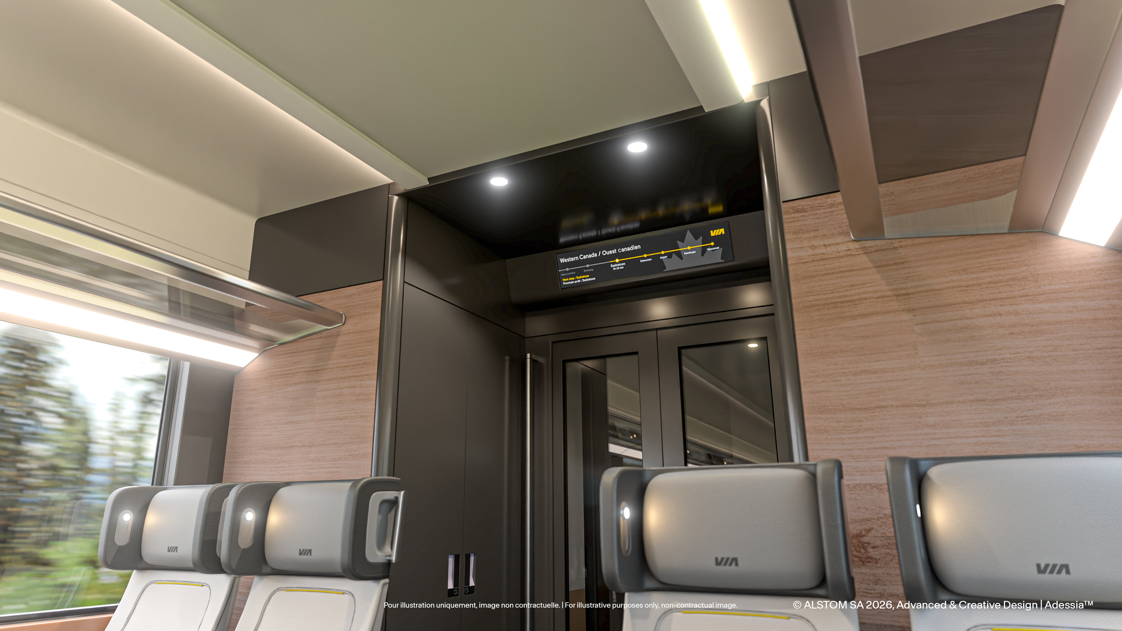 Coach car interior in daylight, showing digital signage, headrest reading lights, glass luggage racks and a full height service cabinet