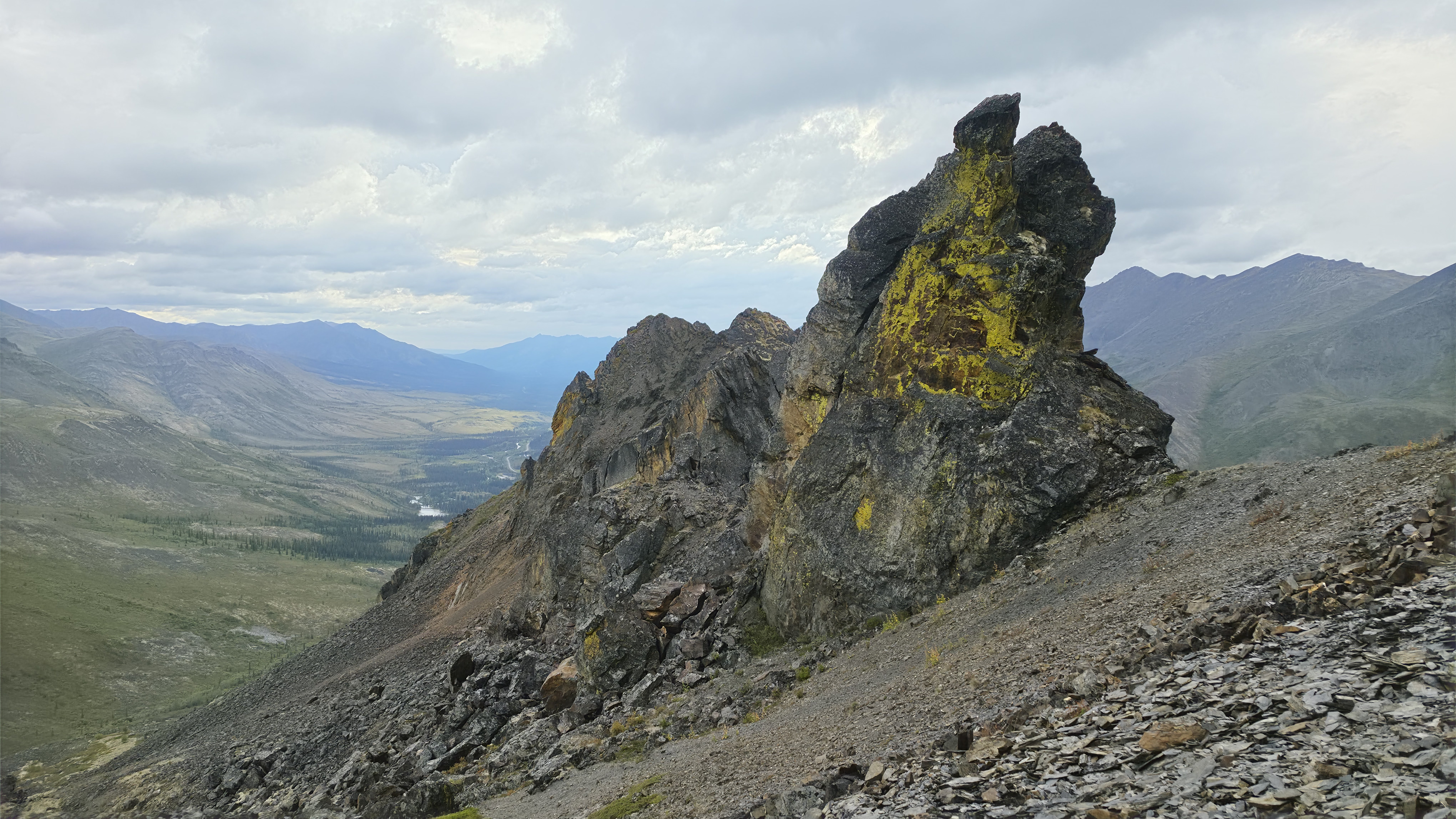 Thin shale towers rising above sloped fans of loose sediment on the shoulder of Mt. Chester Henderson.