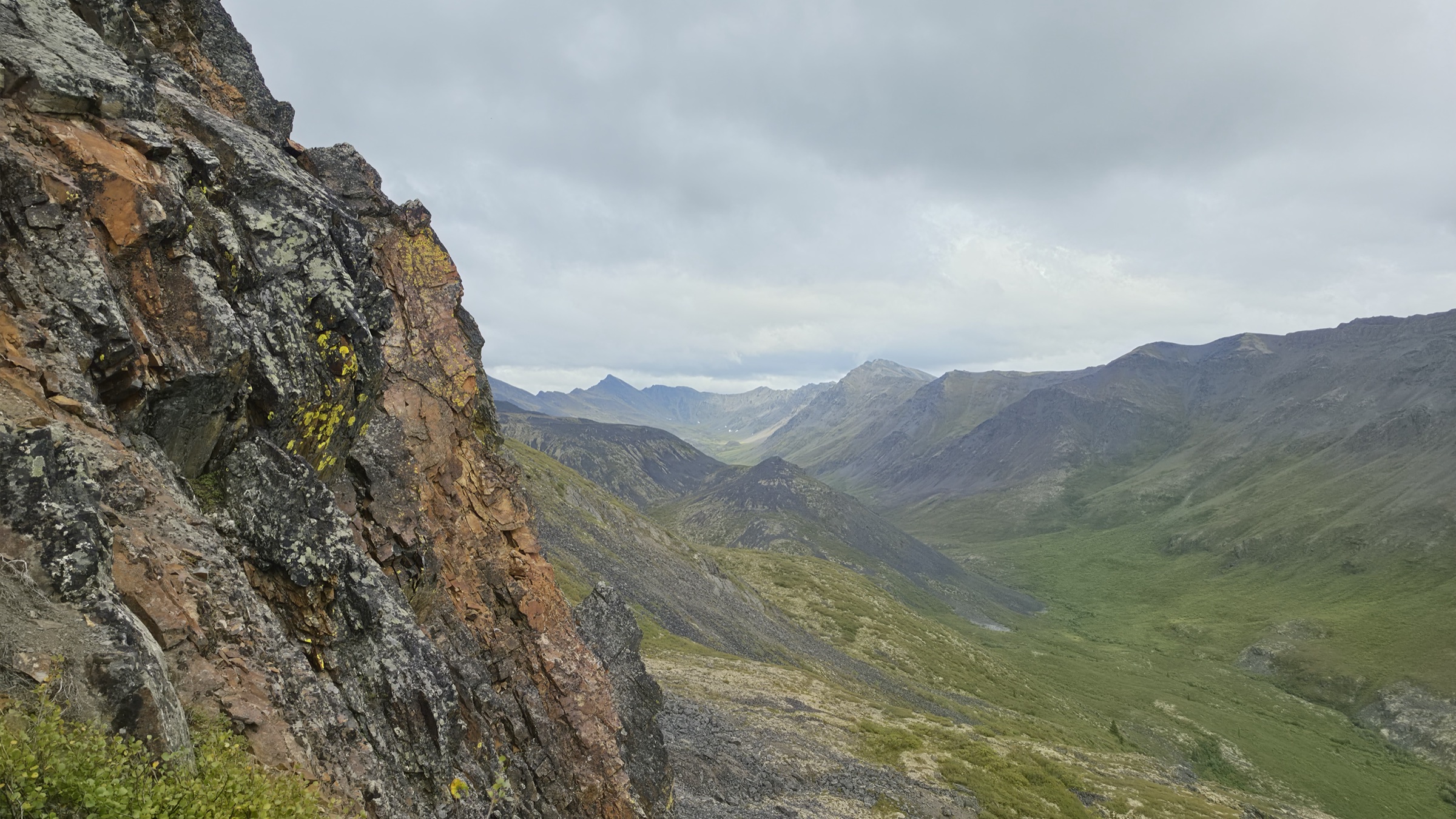 The cirque of Mount Big Alex visible past the edge of a shale spire.