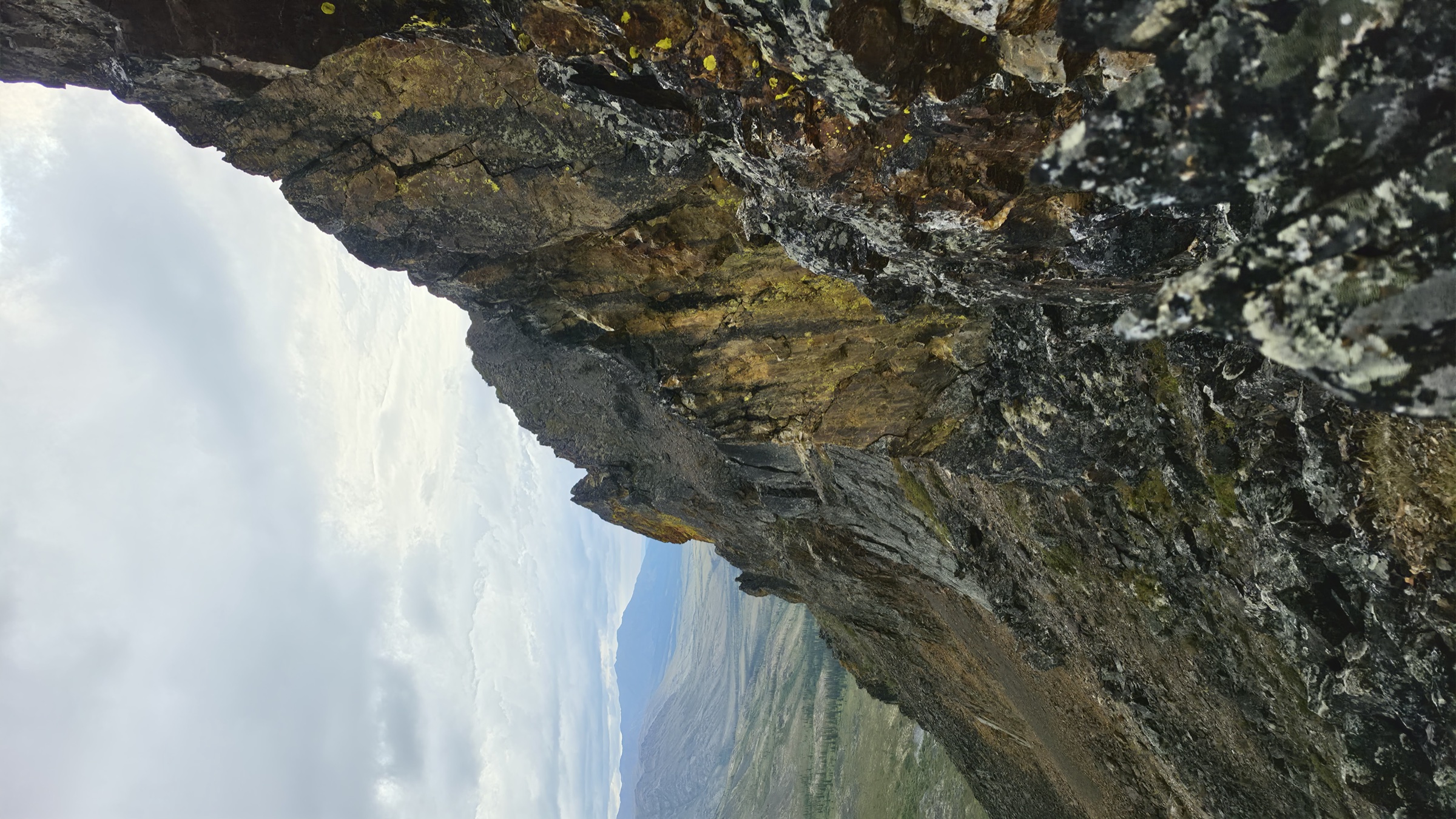 View back along the ridge to the first two shale spires, with layers of terrain receding into the distance.